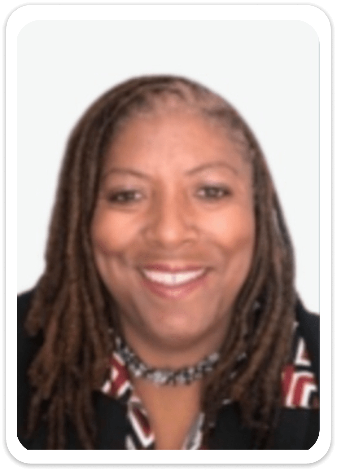 Smiling woman with long braided hair.